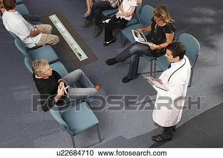 Stock Image - Doctor and patients in waiting area. Fotosearch