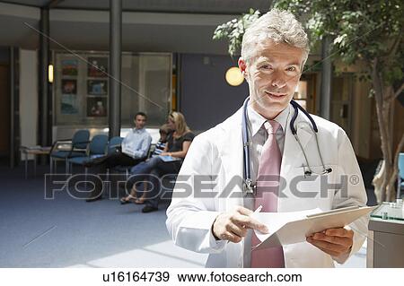 Stock Photo - Doctor and patients in waiting area. Fotosearch