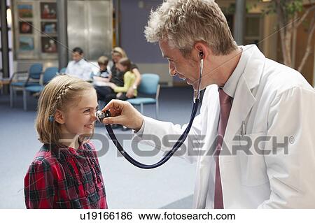 Stock Photograph - Doctor and patients in waiting area. Fotosearch