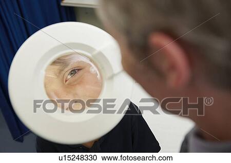 Stock Image - Doctor examining young boy. Fotosearch