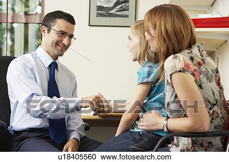 Doctor examining young girl View Large Photo Image Stock Image - Doctor examining young girl. Fotosearch