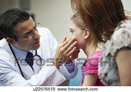 Stock Photo - Doctor examining young girl. Fotosearch