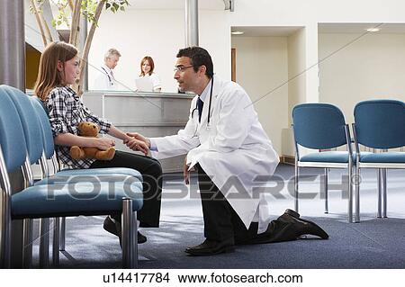Doctor greeting young girl in surgery View Large Photo Image Picture - Doctor greeting young girl in surgery. Fotosearch