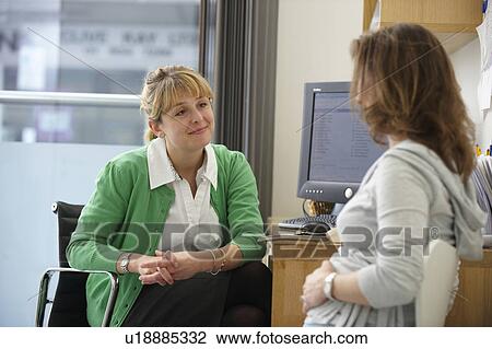 Doctor listening to female patient View Large Photo Image Stock Image - Doctor listening to female patient. Fotosearch