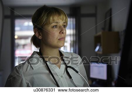 Doctor looking at screen in office View Large Photo Image Stock Image - Doctor looking at screen in office. Fotosearch