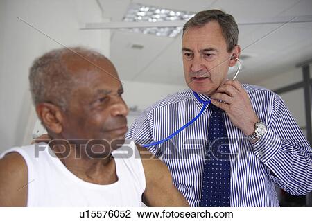 Doctor with stethoscope with elderly man View Large Photo Image Stock Image - Doctor with stethoscope with elderly man. Fotosearch