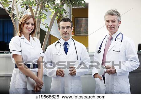 Stock Photography - Doctors and nurse in waiting area. Fotosearch