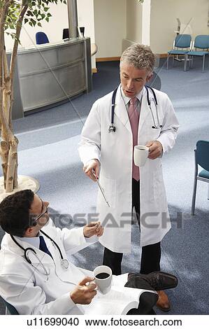 Doctors in waiting area View Large Photo Image Stock Image - Doctors in waiting area. Fotosearch