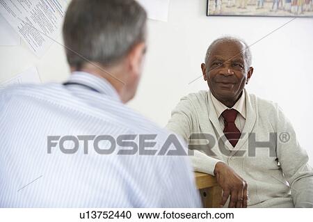 Elderly black man talking to doctor View Large Photo Image Stock Image - Elderly black man talking to doctor. Fotosearch