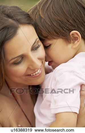 Emotional hug between mother and son View Large Photo Image Stock Photo - Emotional hug between mother and son. Fotosearch