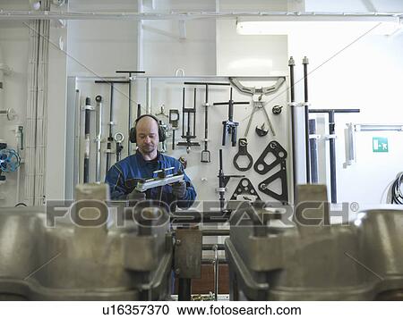 Stock Image - Engineer Checking spare part. Fotosearch