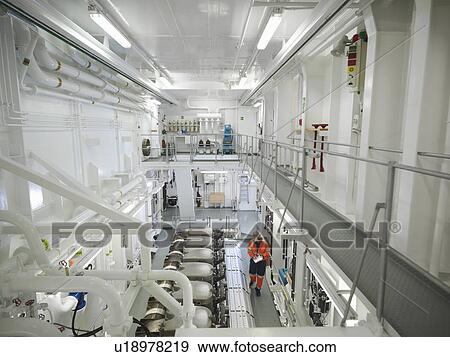 Stock Photo -  Engineer checks ship's engine. Fotosearch