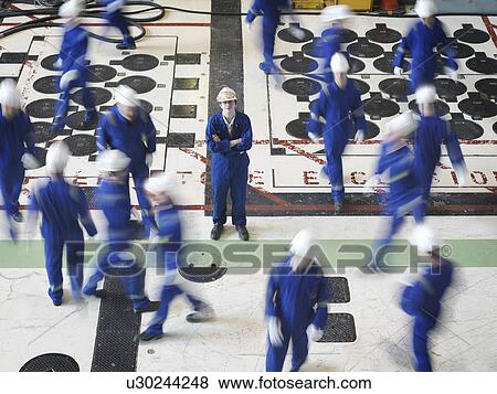 Stock Photo - Engineer in Charging Hall. Fotosearch