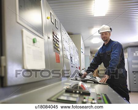 Stock Photography -  Engineer in Control Room of Ship. Fotosearch