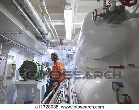 Stock Photo -  Engineer in ship's engine room. Fotosearch