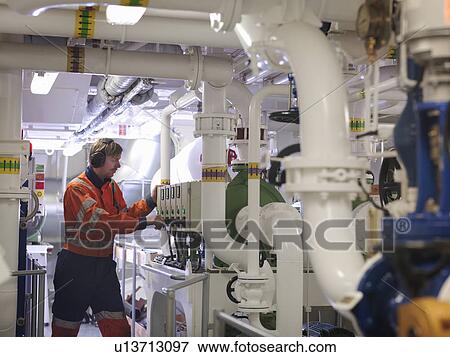 Stock Photo -  Engineer in ship's engine room. Fotosearch