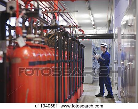 Stock Image - Engineer in Turbine Hall. Fotosearch