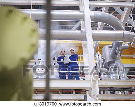 Stock Image - Engineer in Turbine Hall. Fotosearch
