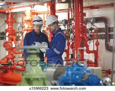 Stock Image - Engineer in Turbine Hall. Fotosearch