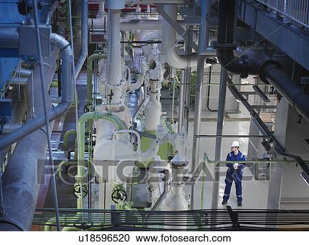 Stock Image - Engineer in Turbine Hall. Fotosearch