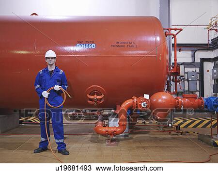 Stock Image - Engineer in Turbine Hall. Fotosearch