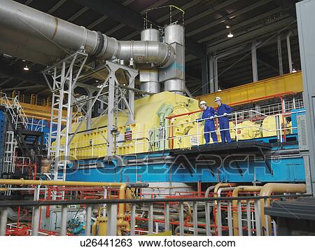 Stock Image - Engineer in Turbine Hall. Fotosearch