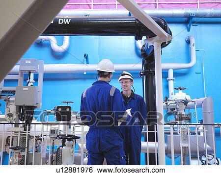 Stock Photograph - Engineer in Turbine Hall. Fotosearch