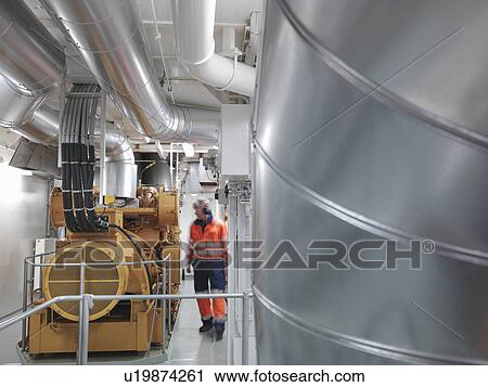 Stock Image - Engineer inspects Generator. Fotosearch