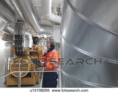 Engineer inspects generator View Large Photo Image Stock Photography - Engineer inspects generator. Fotosearch