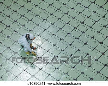 Stock Image - Engineer on Nuclear Reactor Pile cap. Fotosearch