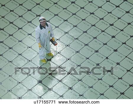 Stock Image - Engineer on Nuclear Reactor Pile cap. Fotosearch