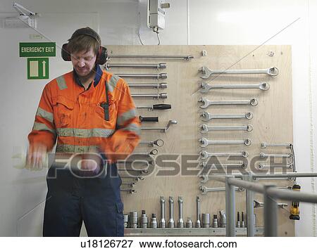 Engineer selecting spanner on board ship View Large Photo Image Stock Photo - Engineer selecting spanner on board ship. Fotosearch