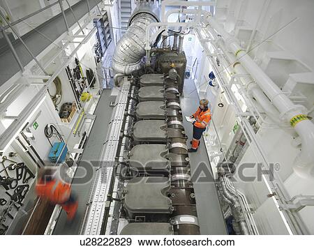 Stock Photo -  Engineers checks ship's engine. Fotosearch