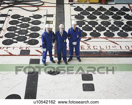 Stock Image - Engineers in Charging Hall. Fotosearch