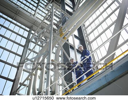 Stock Image - Engineers in Charging Hall. Fotosearch