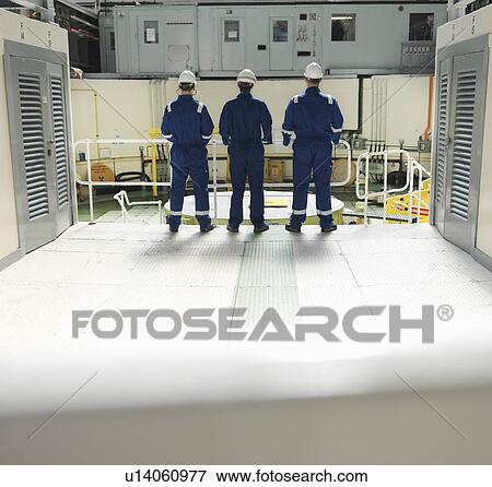 Stock Photo - Engineers in Charging Hall. Fotosearch