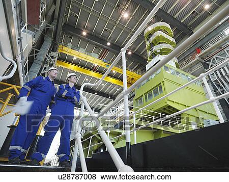 Stock Photo - Engineers in Charging Hall. Fotosearch