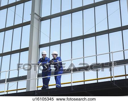 Stock Photography - Engineers in Charging Hall. Fotosearch