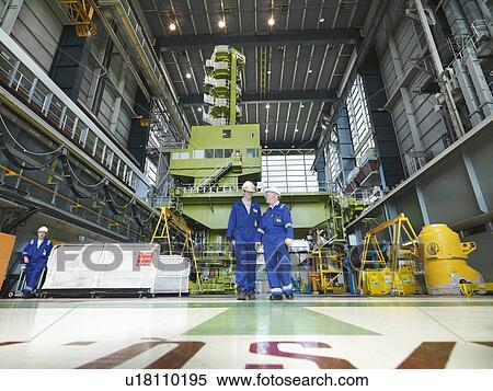 Stock Photography - Engineers in Charging Hall. Fotosearch