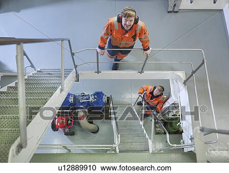 Engineers in ship's engine room View Large Photo Image Stock Image - Engineers in ship's engine room. Fotosearch