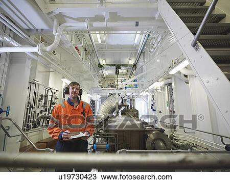 Engineers in ship's engine room View Large Photo Image Stock Image - Engineers in ship's engine room. Fotosearch