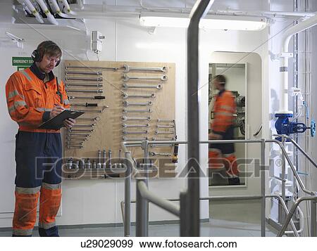 Engineers in ship's engine room View Large Photo Image Stock Photo - Engineers in ship's engine room. Fotosearch