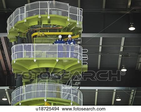 Picture - Engineers on Charging Machine. Fotosearch