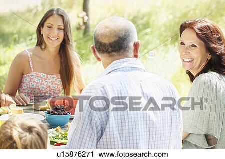Stock Image - Family group at rural picnic. Fotosearch