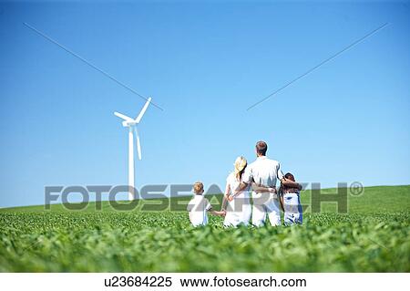 Family looking at wind turbine View Large Photo Image Stock Photography - Family looking at wind turbine. Fotosearch