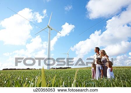 Stock Image - Family looking at wind turbines. Fotosearch