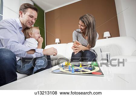 Family playing board game View Large Photo Image Stock Photo - Family playing board game. Fotosearch