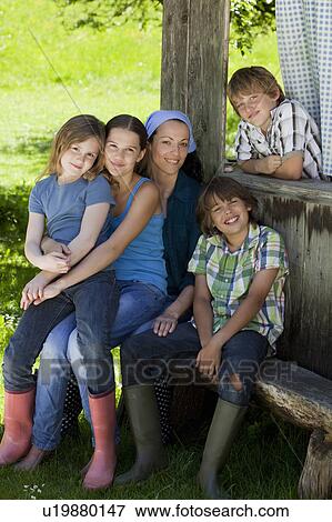 Stock Photo - Family resting on shed, happy. Fotosearch