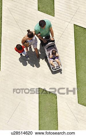 Family walking in city square View Large Photo Image Stock Image - Family walking in city square. Fotosearch