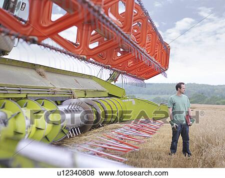 Farmer and combine harvester View Large Photo Image Stock Photo - Farmer and combine harvester. Fotosearch